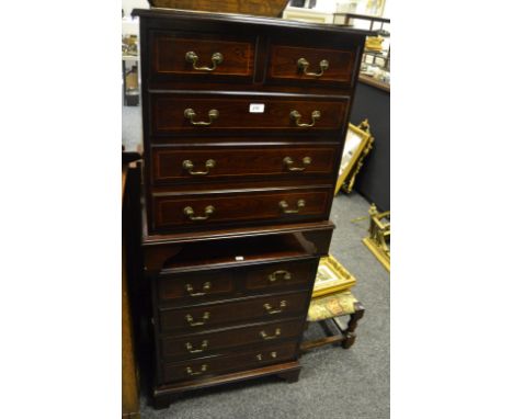 A pair of Georgian revival mahogany bedside cabinets, boxwood stringing throughout, two short above three long drawers, brack