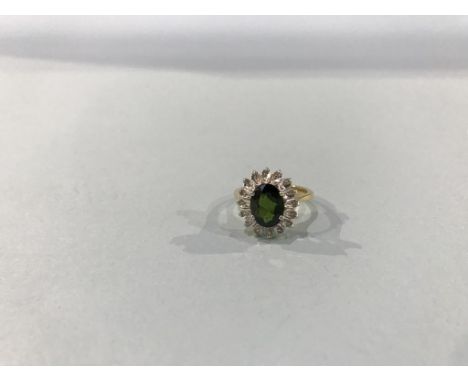 An 18ct gold diamond and emerald ring, 3.8g, size 'J'