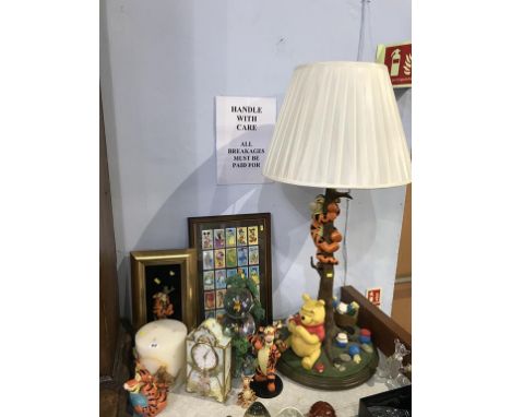 A collection of Winnie the Pooh memorabilia, including large Tigger and Pooh table lamp