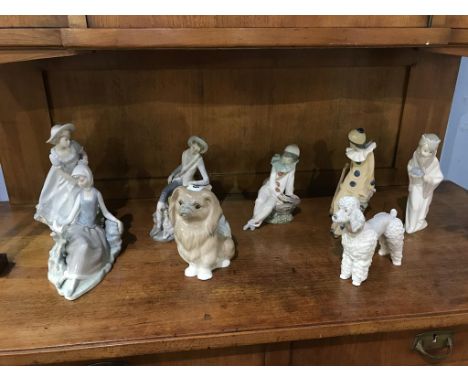 Three Lladro figures, two Lladro dogs, two Nao clowns and a Nadal figure (8)