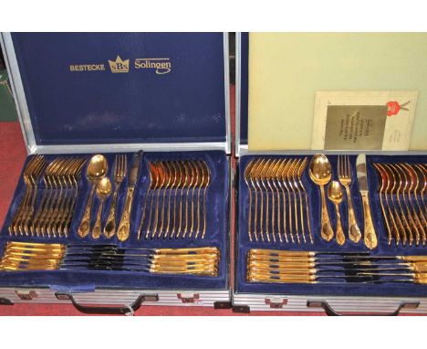 Two Besteck West German twelve-place setting canteens of gold plated cutleryBoth canteens with two tiers; 70 pieces per box.P