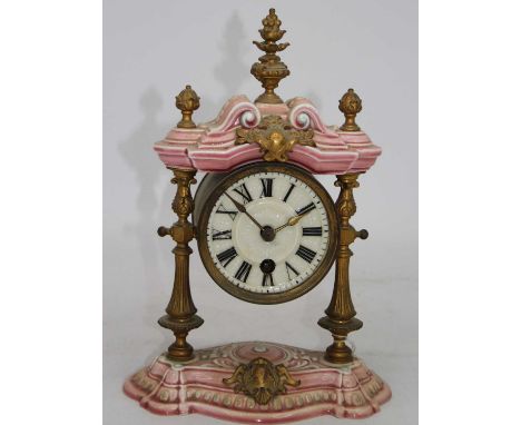 A continental porcelain cased mantel clock, the dial showing Roman numerals, h.29cm 