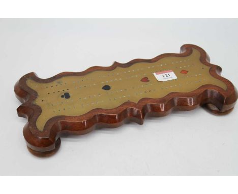 A 19th century brass and mahogany cribbage board, of shaped outline standing on four bun feet, width 33cm