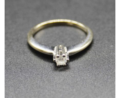An 18ct white gold diamond solitaire ring, the six-claw set brilliant weighing approx 0.13 carats, 2.2g, size J