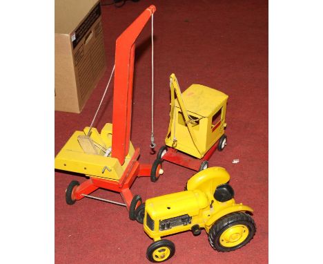A Sutcliffe tin plated model crane, together with a wooden model crane, and a tractor