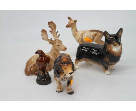 A collection of three Beswick figures to include Corgi "Black Prince" model No. 1299A, Stag model No. 954, and Doe model No. 