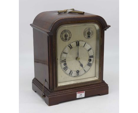 An early 20th century mahogany eight day mantel clock, the silvered dial showing Roman numerals with slow/fast and chime/sile