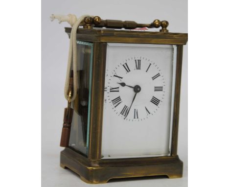 An early 20th century lacquered brass cased carriage clock having an enamel dial with Roman numerals, visible platform lever 