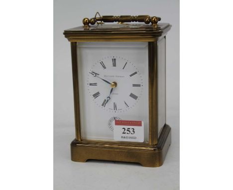 A 20th century lacquered brass cased carriage clock having an enamel dial with Roman numerals and subsidiary second dial, sig
