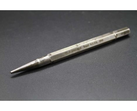 An engine turned silver propelling pencil