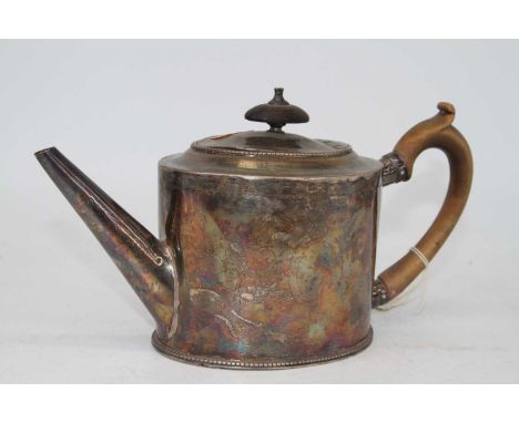 A George III silver teapot, of oval form, having bright cut engraved decoration and fruitwood handle, 13.9oz 