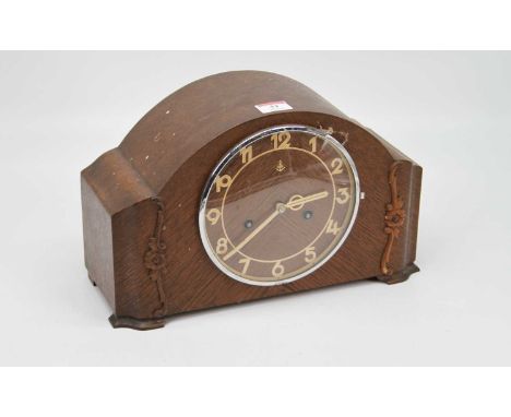 A 1930s oak cased mantel clock, having eight-day movement striking on a gong