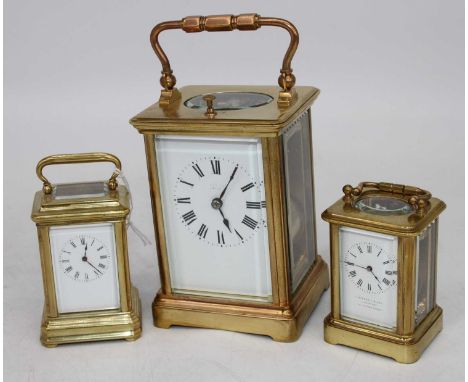 A lacquered brass carriage clock, the enamel dial showing Roman numerals, having visible platform escapement, h.13cm; togethe