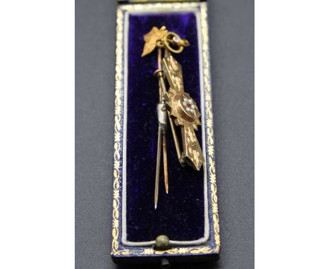 An Edwardian 9ct gold seed pearl and ruby set bar brooch; together with a diamond point set tie-pin; and a yellow metal maple