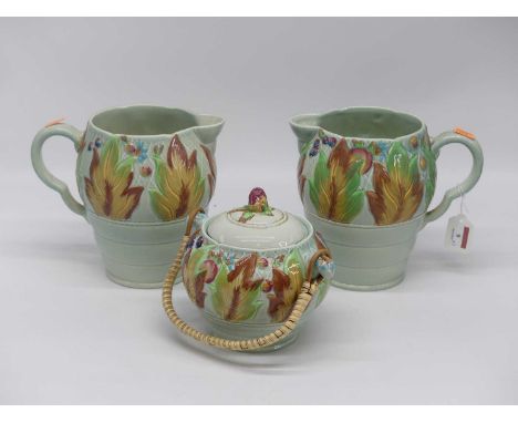 A pair of Clarice Cliff celtic leaf and berry jugs, height 19cm, together with a matching jar and cover (3)Small star crack a