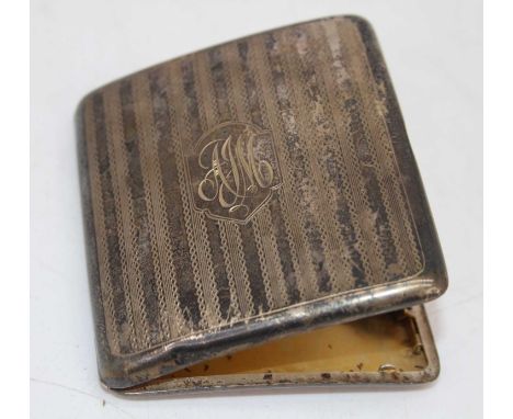 A George V silver pocket cigarette case having monogrammed cartouche, engine turned decoration, and gilt washed interior, 2.8