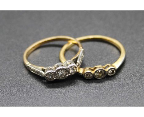 An 18ct gold and platinum diamond three stone ring, size K/L; together with one other similar 18ct gold and platinum example,