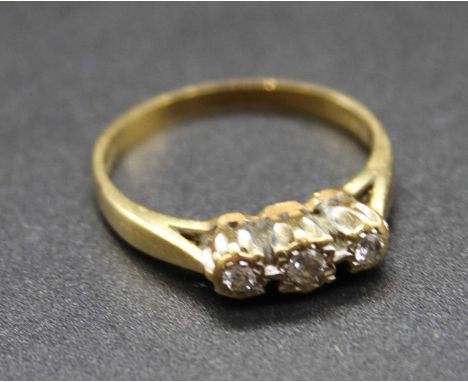 An 18ct gold diamond three stone ring, total diamond weight stated as 0.11ct, 2.7g, size L