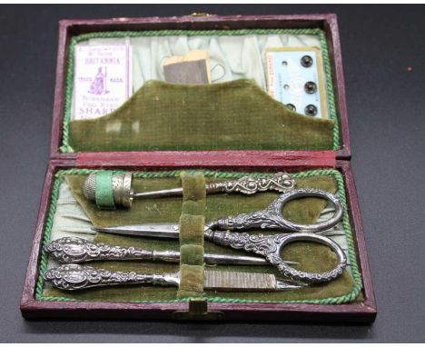 A circa 1900 fitted etui in leather case, width 13.5cmTops marked sterling.Light age related marks
