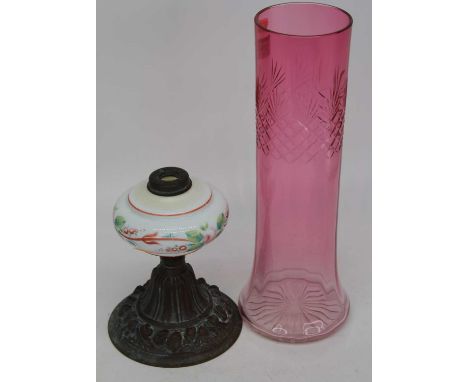 A Victorian copper oil lamp base, having a milk glass font, together with a cranberry glass vase, height 35cm (2)