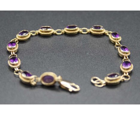 A 9ct gold amethyst bracelet, comprising twelve oval cut amethysts, 6.5g, length 17cmHallmarked on the ring.Light scratches, 