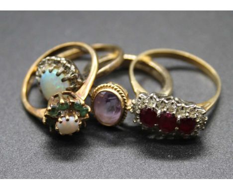 Four various 9ct gold semi-precious set rings, to include opal and green peridot example, amethyst example, and a ruby three 