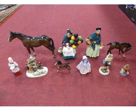 A collection of ceramics to include Royal Doulton figures 'The Orange Lady' and 'The Old Balloon Seller', Beswick horses, etc