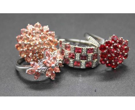 Four various modern white gold precious and semi precious dress rings, to include ruby and diamond point example, sponsor R&a