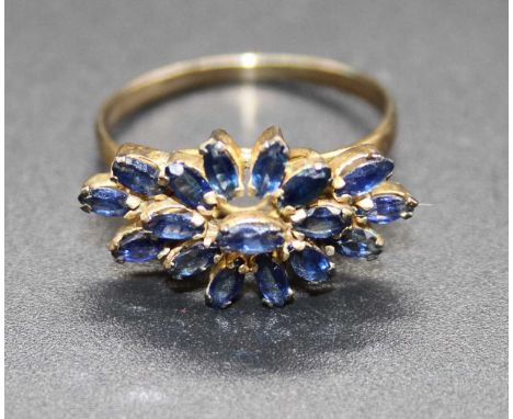 A contemporary yellow metal multi-sapphire flower head cluster ring, unmarked but tests as approx 9ct, 2.2g, size N