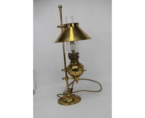 An early 20th century brass student's desk lamp, later converted for electricity, height 61cmIn good order.  Converted for el