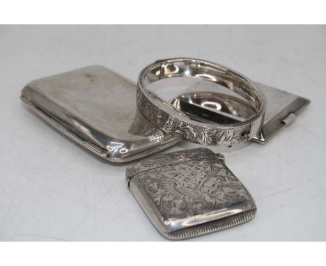 A George V silver pocket cigarette case monogrammed SG, together with a George V silver vesta having all over foliate engrave