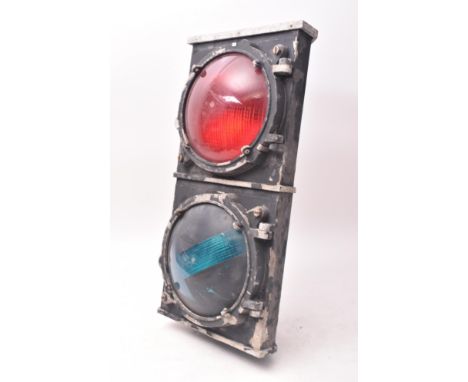 A vintage 20th century traffic light lamp. Aluminium case finished in black with red and green traffic control lights. Measur