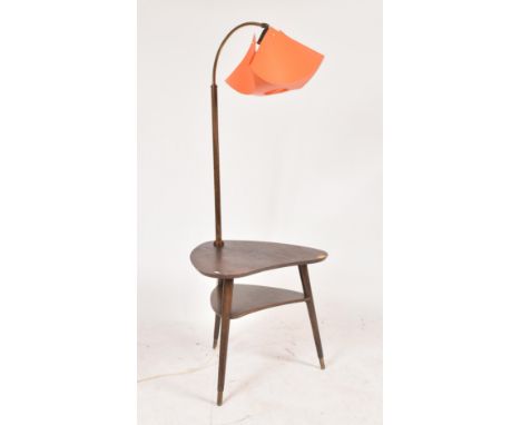 A vintage mid 20th century teak wood side occasional table lamp combination. The table having a tall wooden stem and brass sw