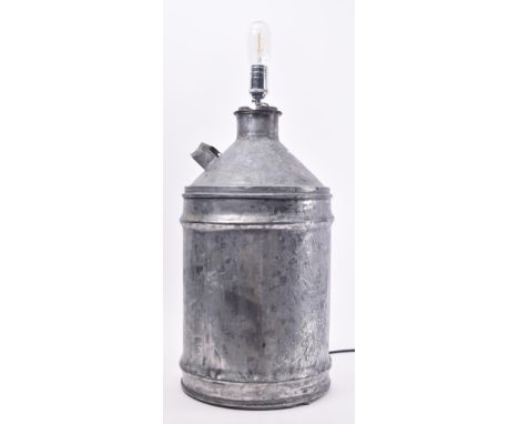 A vintage 20th century upcycled galvanized oil can lamp light. The lamp with light fixing to the top with cylindrical body be