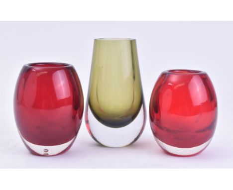 Whitefriars - A selection of three retro 20th century glass vase. The lot comprising of two ruby red vases of bulbous form. T