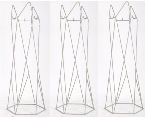 Three contemporary designer retro inspired coat stands. Each coat stand having shaped wire supports with hooks to the top and