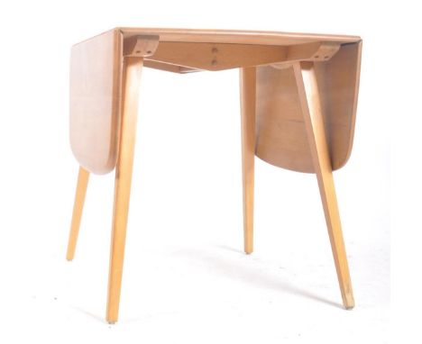 Lucian Ercolani - Ercol Furniture - A retro mid 20th century light beech &amp; elm drop leaf dining table having round edges 