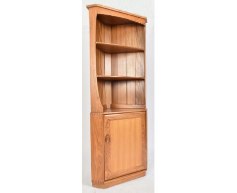 Ercol - Windsor Model - A retro 20th century blonde elm corner cabinet unit. The unit having three shelves over a single door