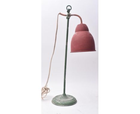 A retro mid 20th century French continental industrial desk table lamp light. The lamp having a red painted conical shade ove