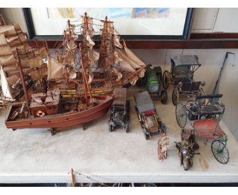 A collection of model boats and model cars together with a John Deere tractor