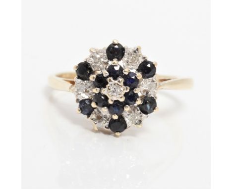 A hallmarked 9ct yellow gold diamond and sapphire tiered design cluster ring, ring size L