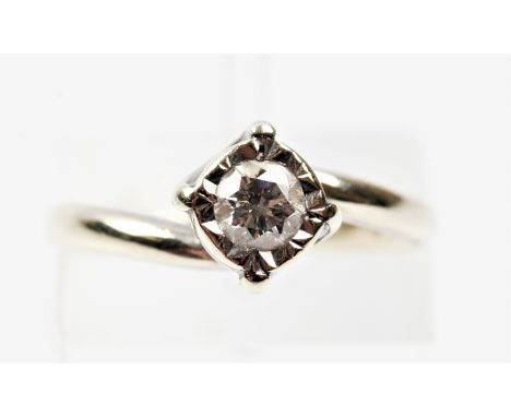 A hallmarked 9ct white gold diamond solitaire ring, illusion set with a round brilliant cut diamond measuring approx. 0.30ct,