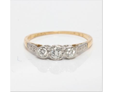 A hallmarked 18ct yellow gold three stone diamond ring, set with three graduated round brilliant cut diamonds, total diamond 