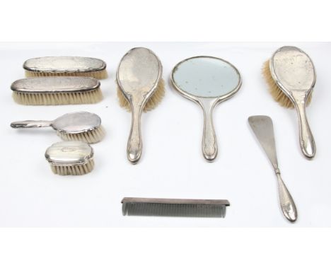 A hallmarked silver dressing table set, comprising of two hair brushes, a mirror, and two clothes brush, along with a child's