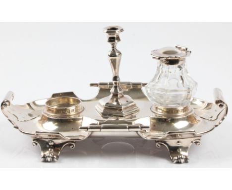 A Victorian silver desk stand with ink well and candlestick holder, desk stand of scroll edge design with space for two ink w