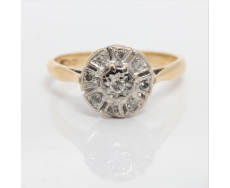 A diamond cluster ring, indistinctly stamped, ring size M