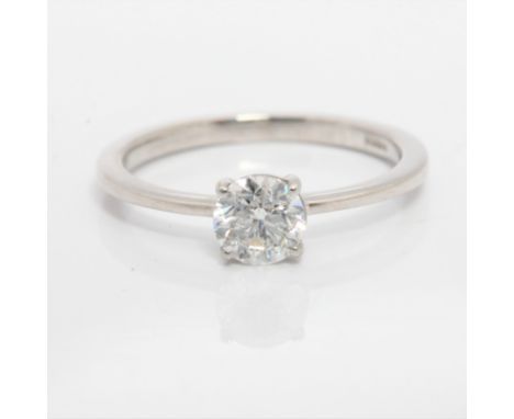 A hallmarked platinum diamond solitaire ring, set with a round brilliant cut diamond measuring approx. 0.60ct, to plain band,