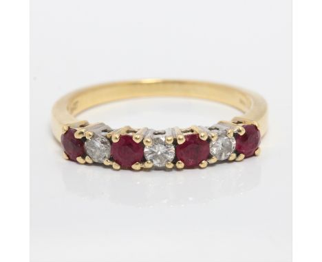 A hallmarked 18ct yellow gold ruby and diamond half eternity ring, set with four round cut rubies separated by three round br