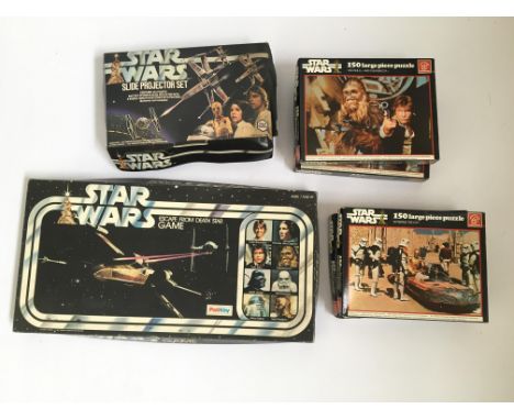 A collection of Star Wars toys to include four large piece puzzles, one slide projector set and one Escape from Death Star ga