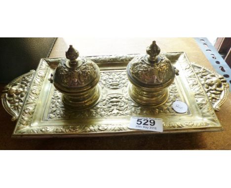 BRASS TWIN INKWELL. Large brass twin inkwell stand with interior ceramic pots in foliate design, L ~ 32cm